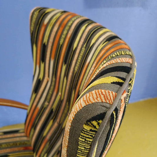 Dettaglio nuovo tessuto tonalità calde contrasto legno naturale poltrona danese