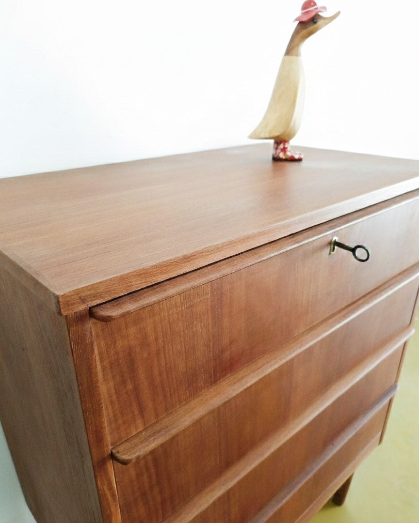 Dettaglio piano superiore in teak della cassettiera danese anni 50, venatura del legno naturale e profilo del bordo
